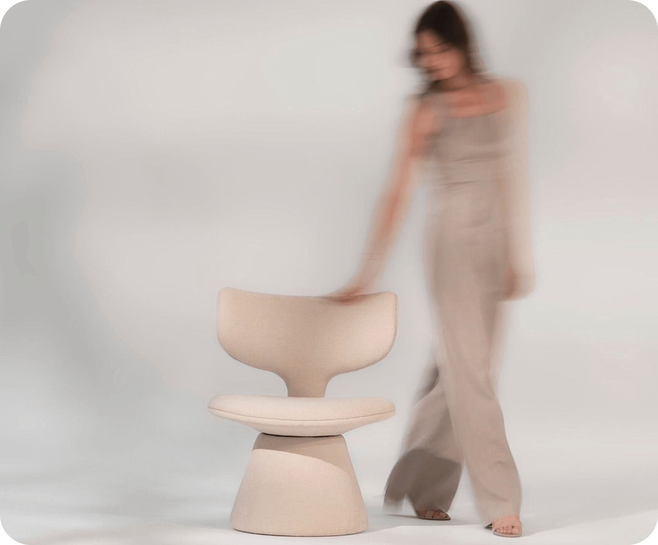 Woman walking past a chair, in motion blur