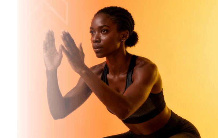 Woman in a sports top, hands raised
