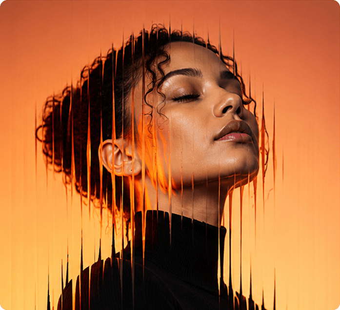 Woman with her eyes closed, face in orange light