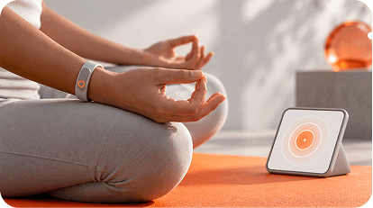Person meditating beside a breathing device