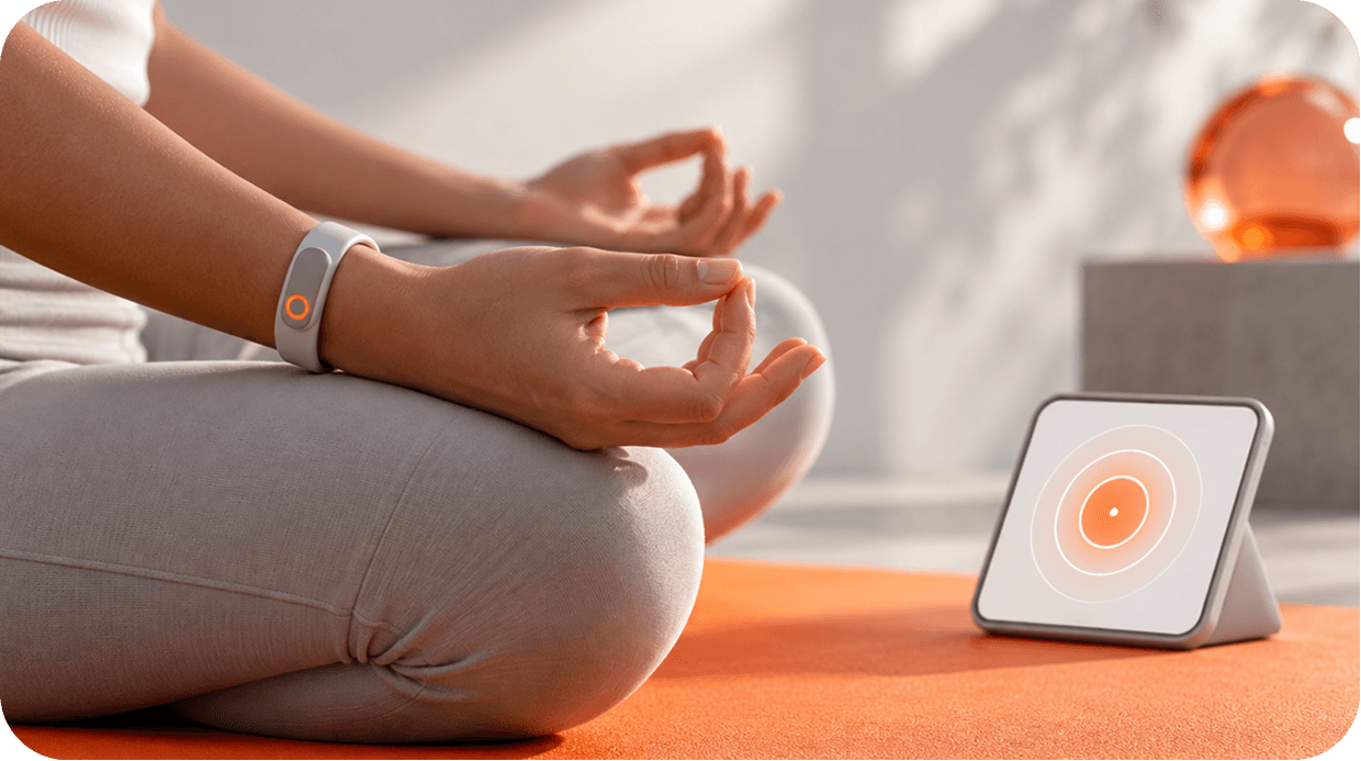 Person meditating beside a breathing device