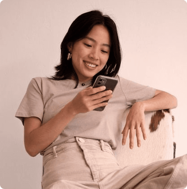 Woman smiling at her phone