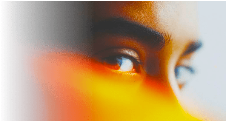 Close-up of an eye in orange light
